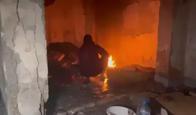 Metruk binada ateş yaktı, çıkmamak için direndi